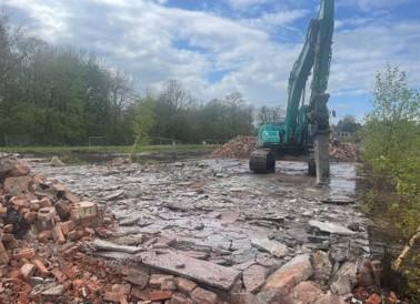 BREAKING OUT FLOOR SLAB AND UNDERGROUND STRUCTURES for Harrow Estates at Woodford Aerodrome